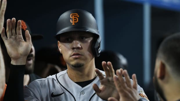 Jul 21, 2022; Los Angeles, California, USA; San Francisco Giants third baseman Wilmer Flores (41) greeted in the dugout after walking in a run in the eighth inning against the Los Angeles Dodgers at Dodger Stadium. Mandatory Credit: Richard Mackson-USA TODAY Sports